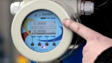 A hand pointing to a Euromag flow meter