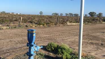 A bush lands road with a Bermad pipe in the foreground.
